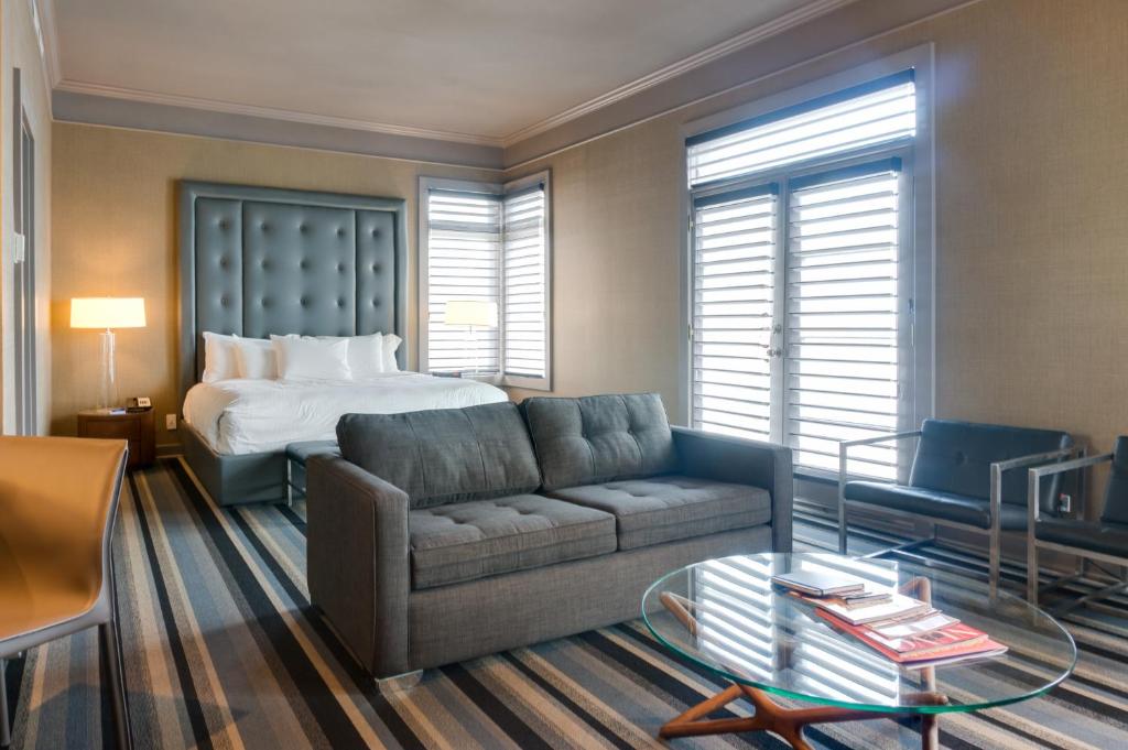 a living room with a couch and a bed at Hotel Arts Kensington in Calgary