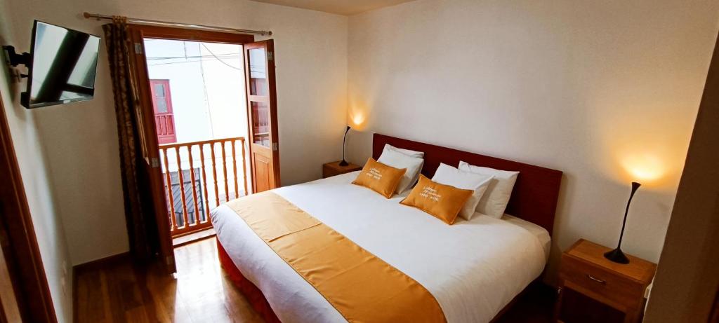 Voodi või voodid majutusasutuse 7th Wonder Apart Hotel Cusco toas