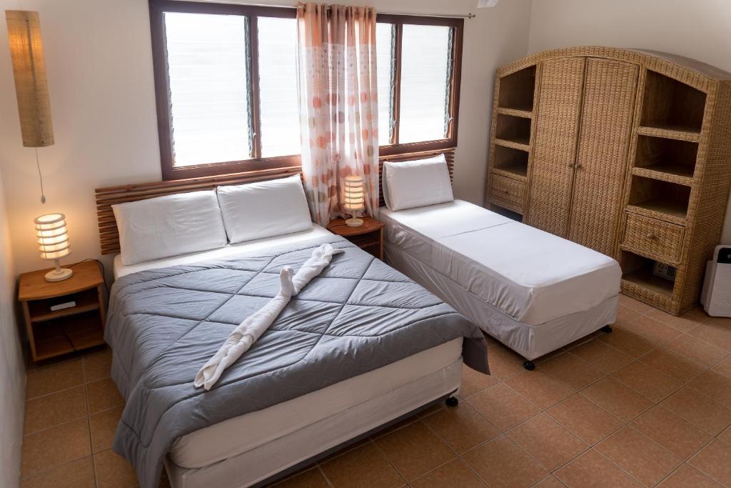 Postel nebo postele na pokoji v ubytování Quo Vadis Dive Resort