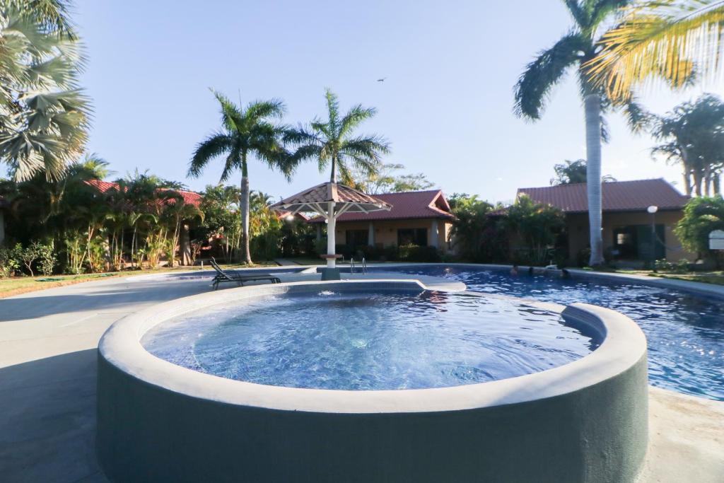 a hot tub in the middle of a yard with palm trees at Villaggio Claudia 29B in Potrero