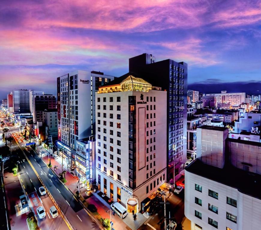 a view of a city at night with buildings at Hotel Leo in Jeju