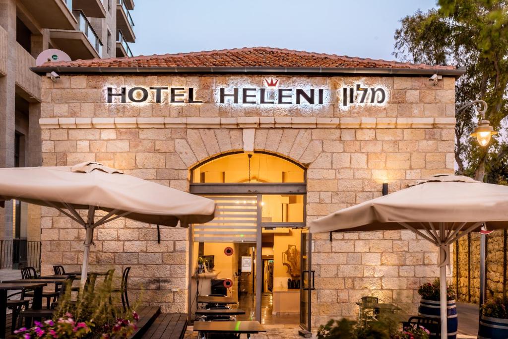 a hotel heisan inn with two umbrellas in front at Olive Heleni Hotel in Jerusalem