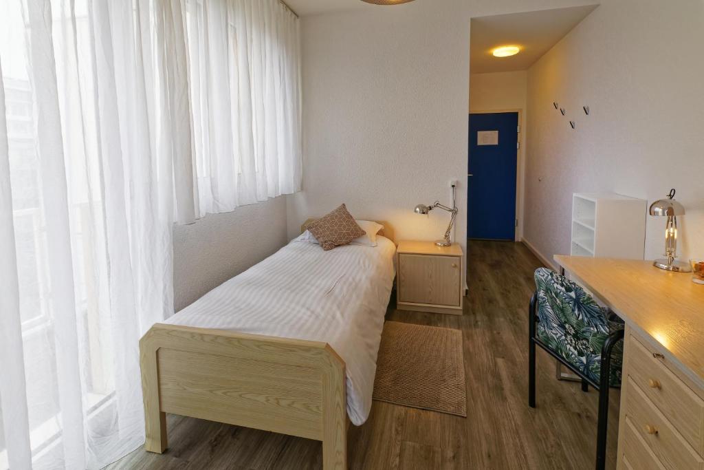 Postel nebo postele na pokoji v ubytování Les Chambres du CTN