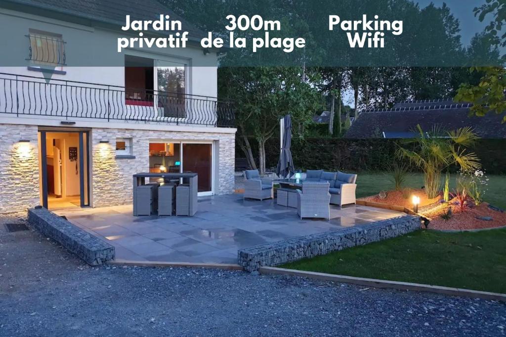 d'une terrasse avec des chaises et une table dans la cour. dans l'établissement Côté Mer - Jardin privatif à 200m de la plage, à Ver-sur-Mer