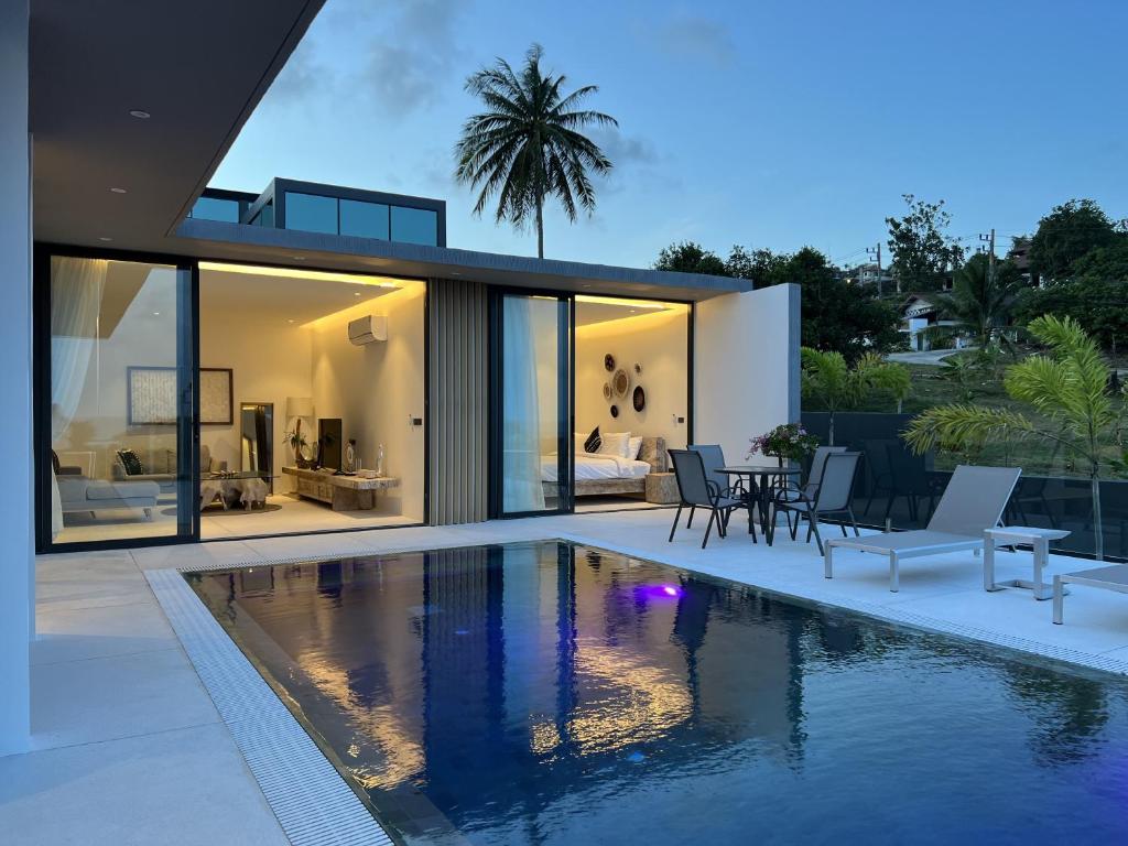 a house with a swimming pool in front of it at AURA AIR 1, pool & seaview villa, Choengmon 500m in Koh Samui 
