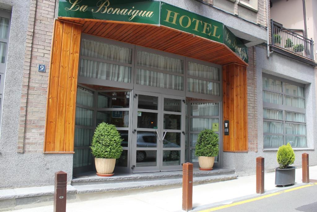 a hotel building with potted plants in front of it at Hotel La Bonaigua in Vielha