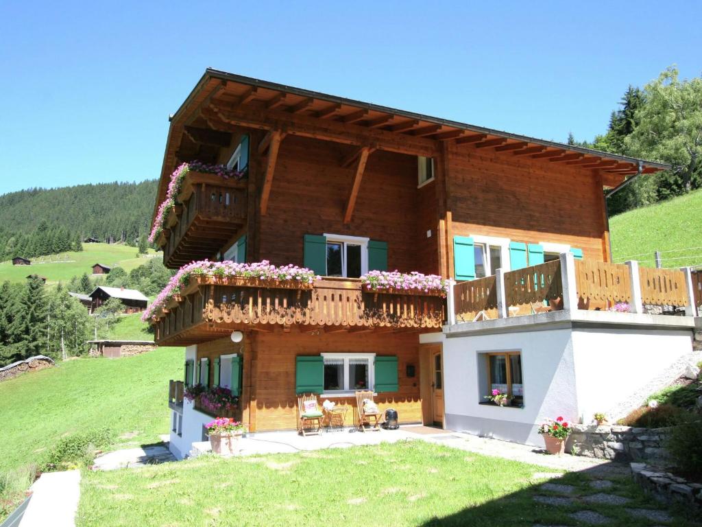 a large house with a balcony on a hill at Lush Apartment in Silbertal with Garden in Silbertal