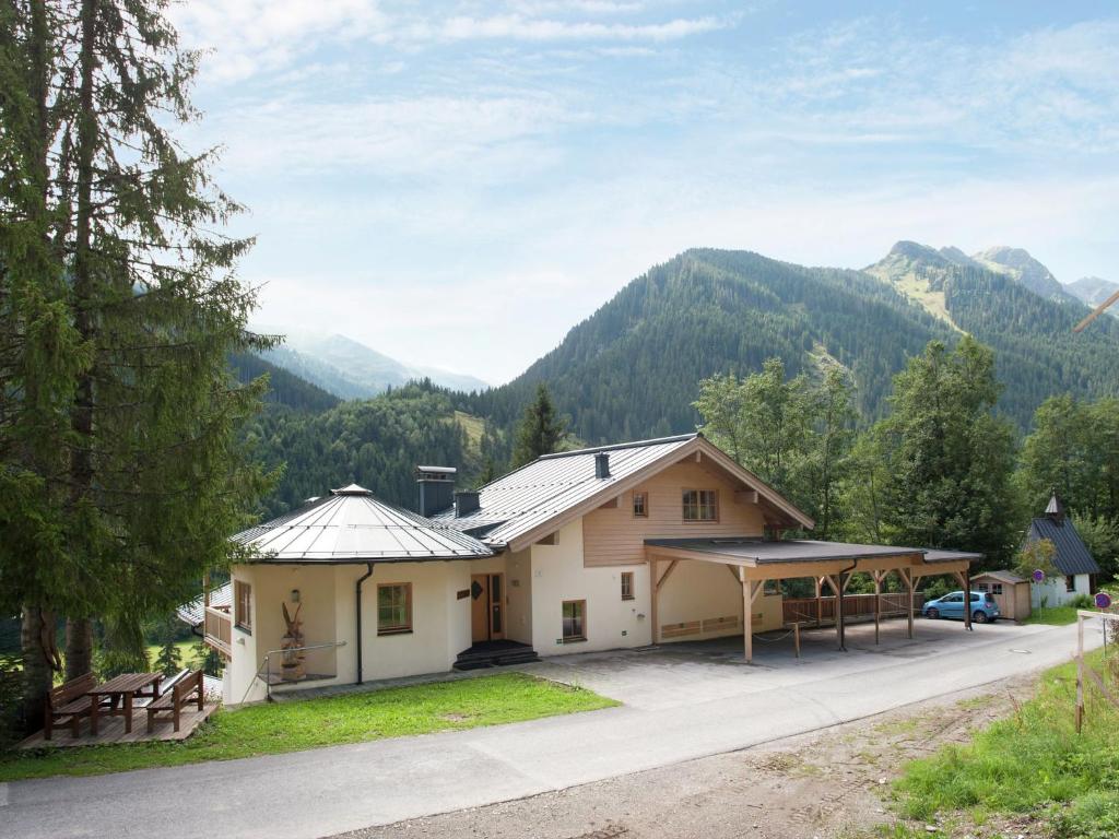 a house with a view of the mountains at Lovely Chalet with Sauna Ski Storage Heating Carport in Saalbach Hinterglemm