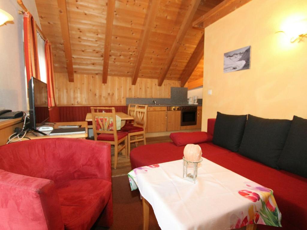 a living room with a couch and a table at Quaint Apartment in L ngenfeld with Sauna in Huben