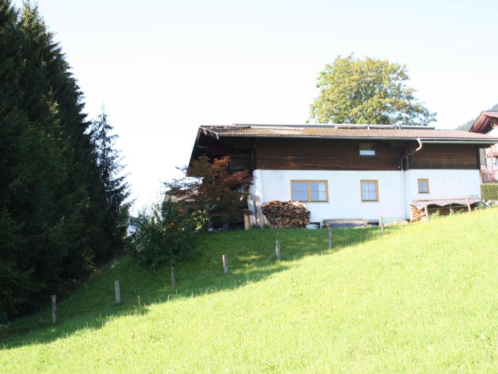 a house on the side of a grassy hill at Spacious Chalet in Flachau with Sauna in Flachau