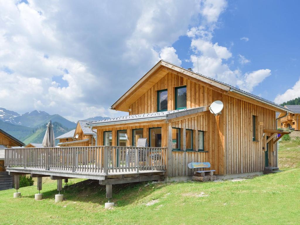 una grande casa in legno con un ampio ponte di Wooden chalet in Hohentauern with sauna a Hohentauern