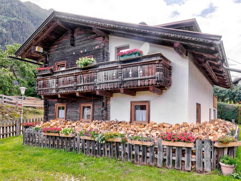 a house with a bunch of chickens in front of it at Welcoming Holiday Home with Garden in Tyrol in Matrei in Osttirol