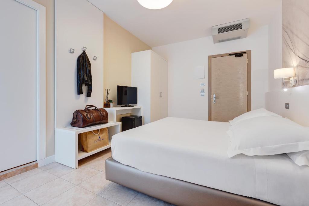 Postel nebo postele na pokoji v ubytování Hotel Nettuno
