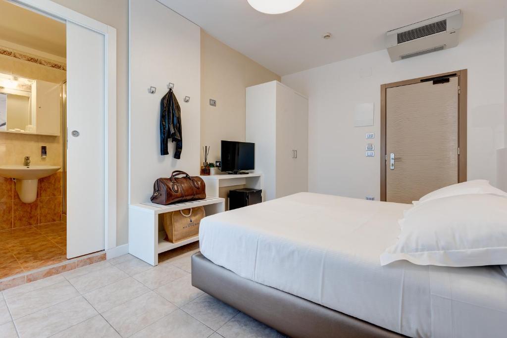 Postel nebo postele na pokoji v ubytování Hotel Nettuno
