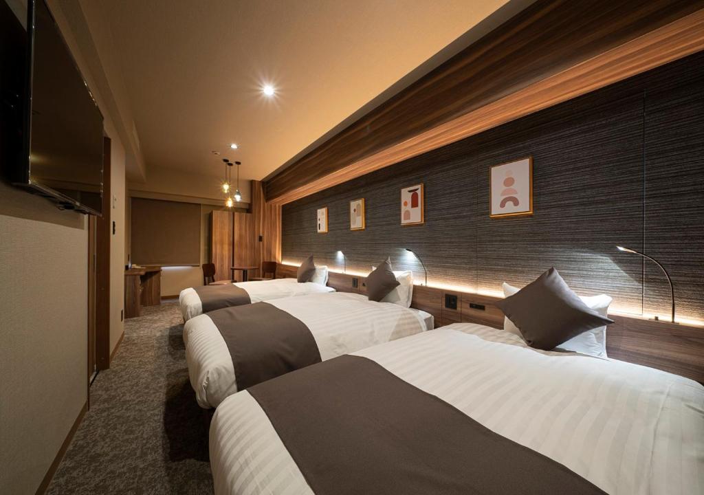 Postel nebo postele na pokoji v ubytování Nagoya B's Hotel