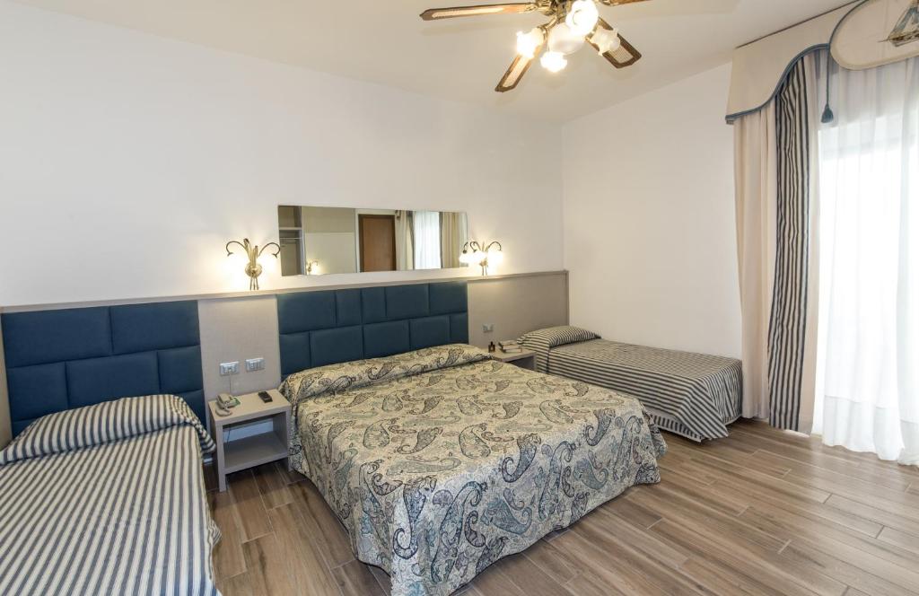 Postel nebo postele na pokoji v ubytování Hotel Nettuno