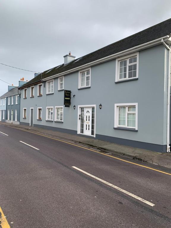 a row of white houses on the side of a street at Dingle Harbour Nights - Room Only in Dingle