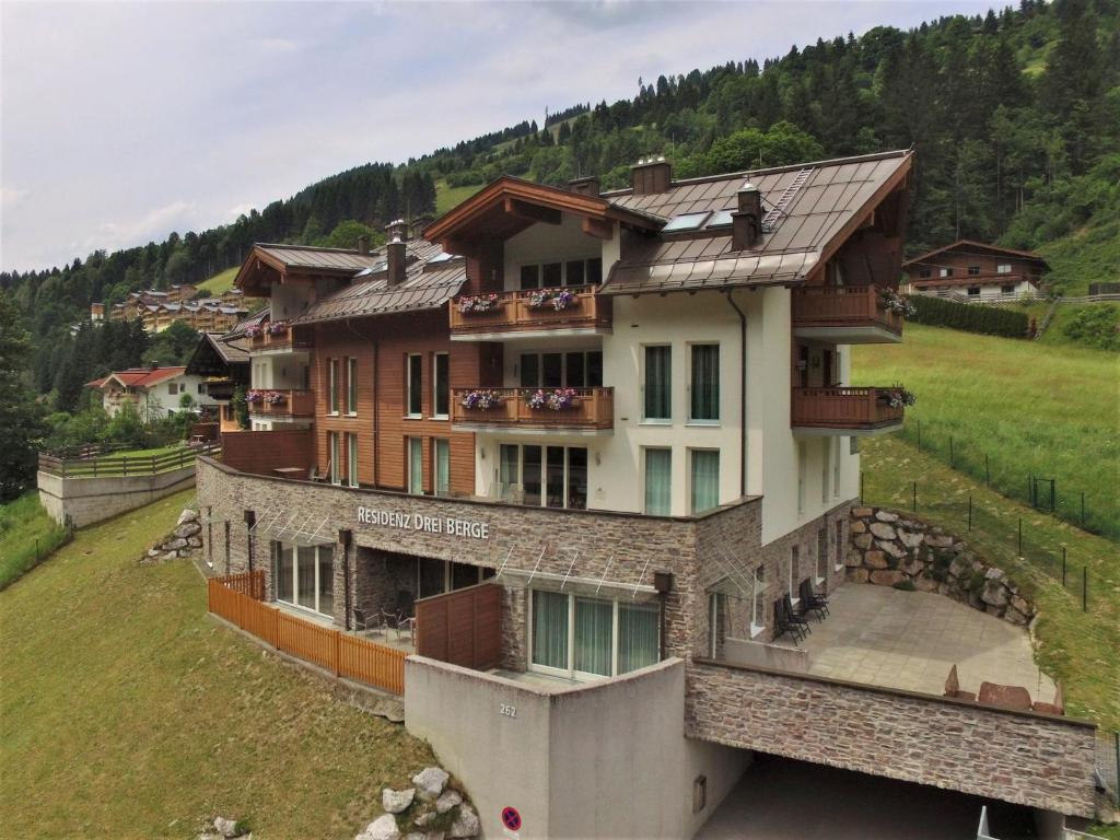a large building on top of a hill at Modern apartment near Saalbach Hinterglemm in Viehhofen