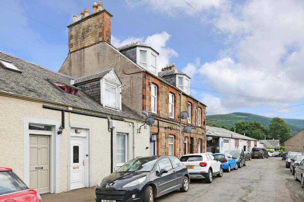 uma rua da cidade com carros estacionados na rua em One bed apartment in the heart of Innerleithen em Innerleithen