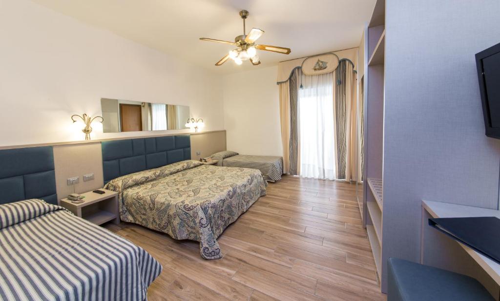 Postel nebo postele na pokoji v ubytování Hotel Nettuno