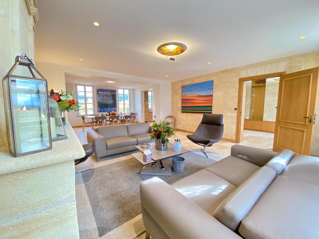 a living room with a couch and a table at Petit Monlot - Saint-Emilion in Saint-Émilion