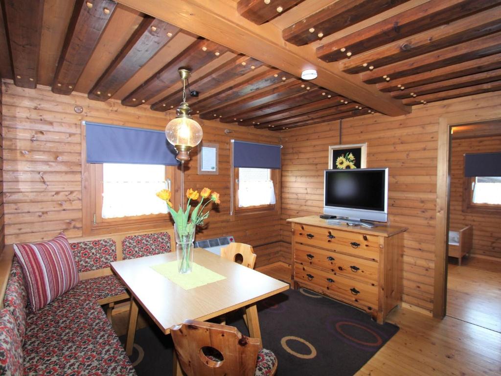 a room with a wooden cabin with a table and a tv at Beautiful holiday apartment in a renovated farmhouse in Fresach Carinthia in Fresach