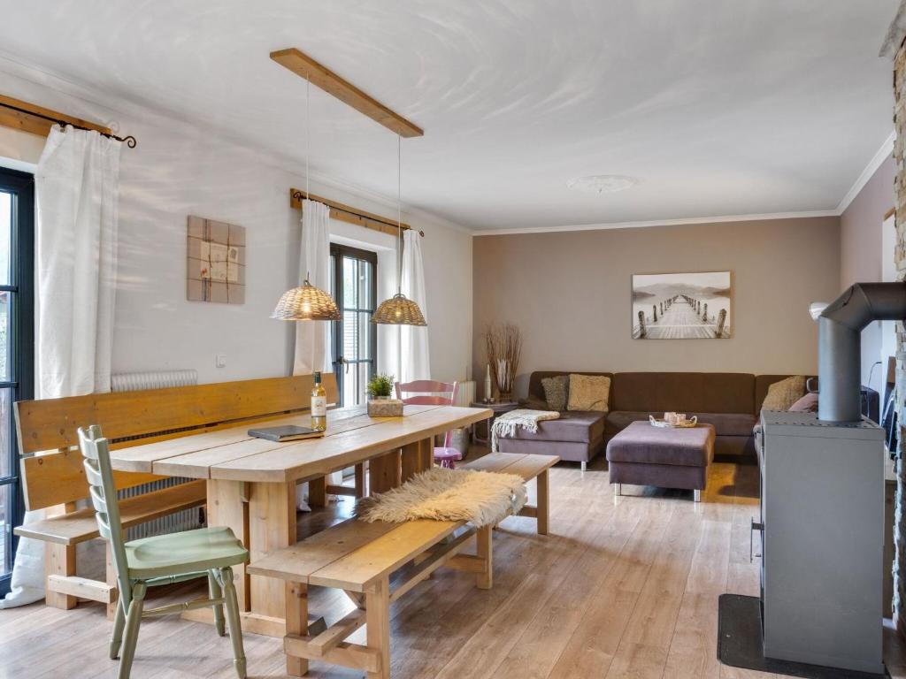 a living room with a table and a couch at Stylish holiday apartment in Leogang Salzburgerland with terrace in Leogang