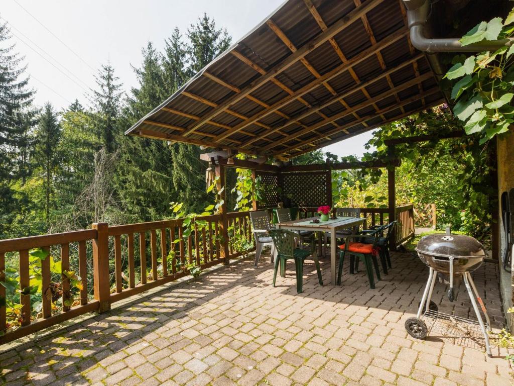 a patio with a grill and a table and chairs at Apartment near the Koralpe ski area 