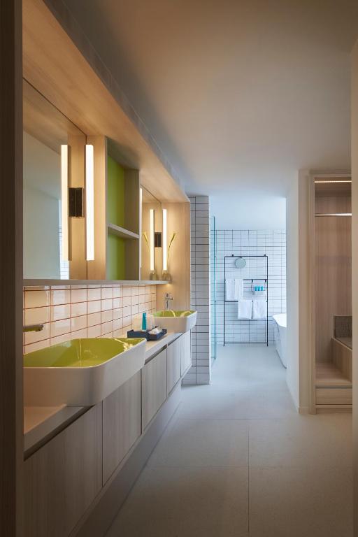 A contemporary bathroom vanity leads toward a tiled shower area.
