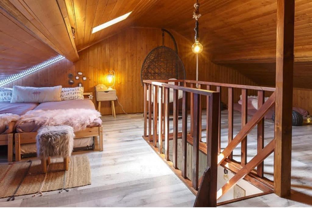 a bedroom with a bed in a wooden cabin at Casa Do Bispo pereiro,Arganil in Coimbra