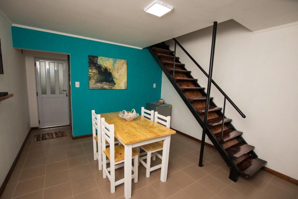 a dining room with a table and a staircase at Häuschen in Colonia San Miguel