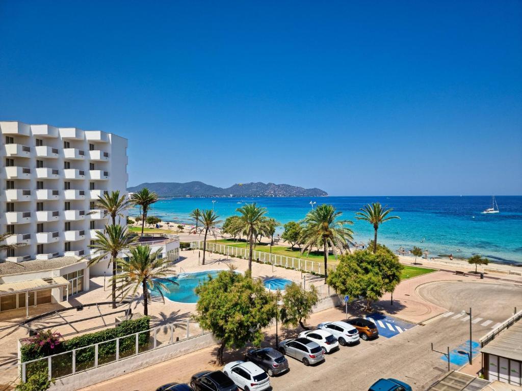 a view of the beach and the ocean from a hotel at Modern apartment with stunning sea view in Cala Millor