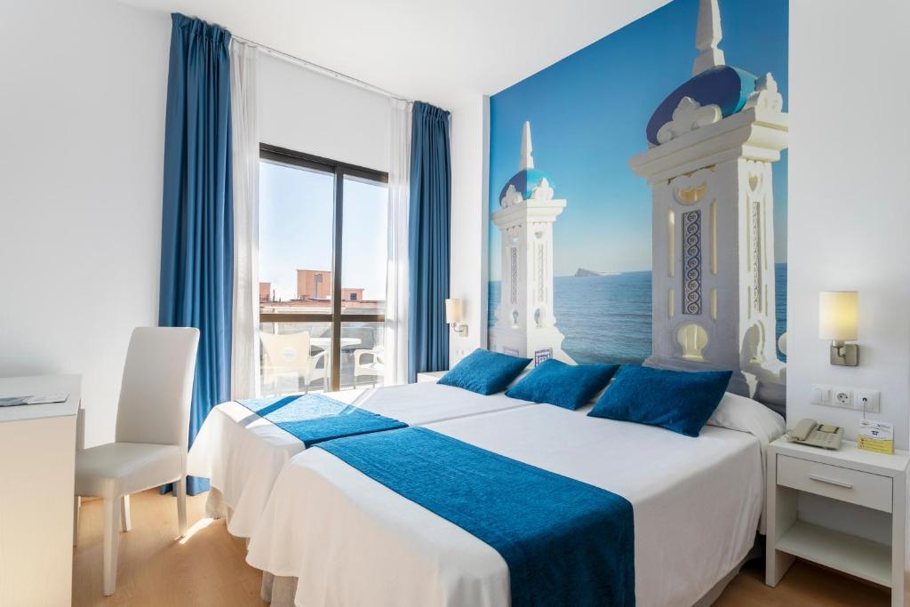 Postel nebo postele na pokoji v ubytování Hotel Avenida