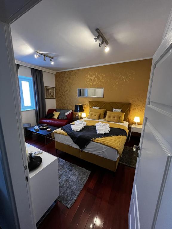 a bedroom with a bed and a living room at Studio apartment Sofia in Poreč