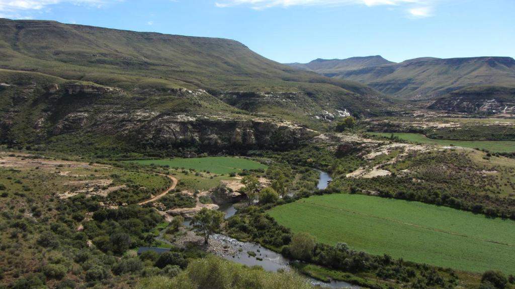 an aerial view of a valley with a river and mountains at Lupela Lodge in Lady Grey