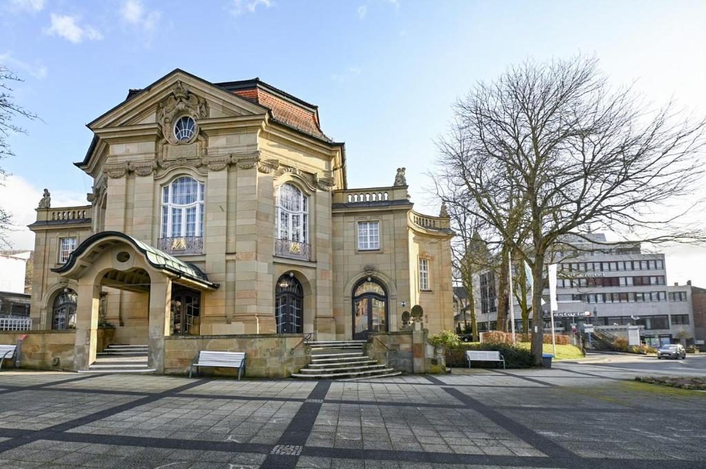 a large stone building with a clock on it at Hotel Rhönkitz in Bad Kissingen