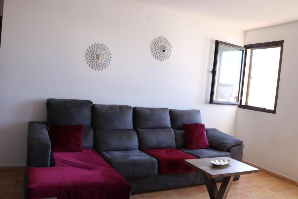 a living room with a couch and a table at Apartamentos La Carmen in Arrecife
