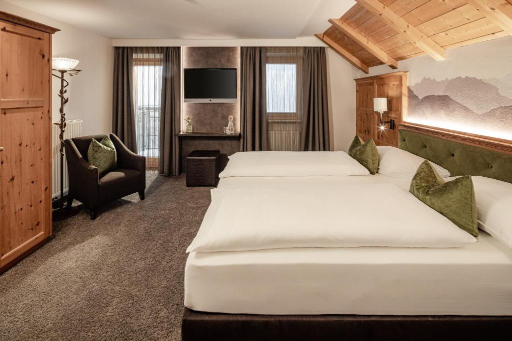 Postel nebo postele na pokoji v ubytování Boutique & Fashion Hotel Maciaconi - Gardenahotels