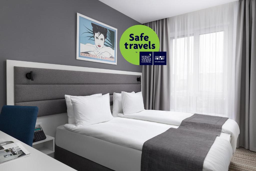 a hotel room with two beds and a sign that says sale traps at 1 ART HOTEL in Moscow