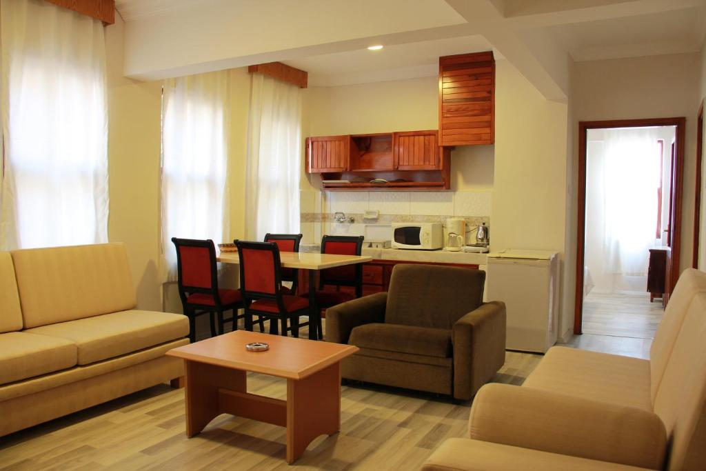 a living room with a couch and chairs and a table at Luxor apartments in Alanya