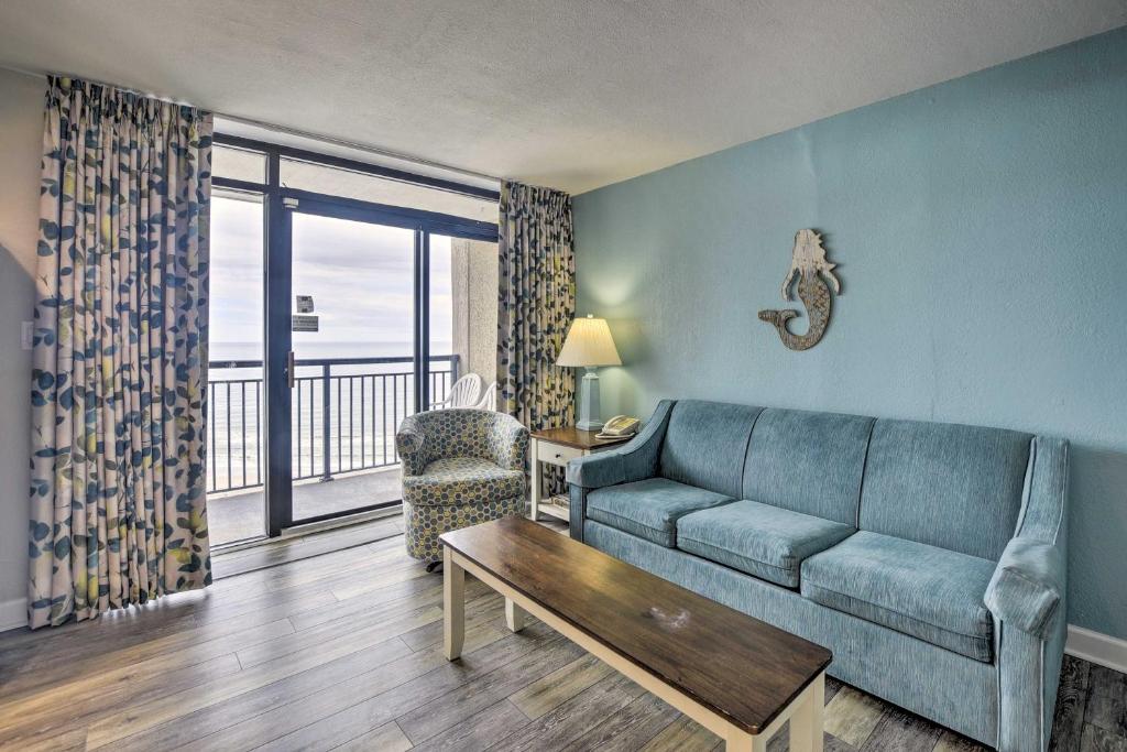 a living room with a couch and a table at Oceanfront North Myrtle Beach Condo with Views! in Myrtle Beach