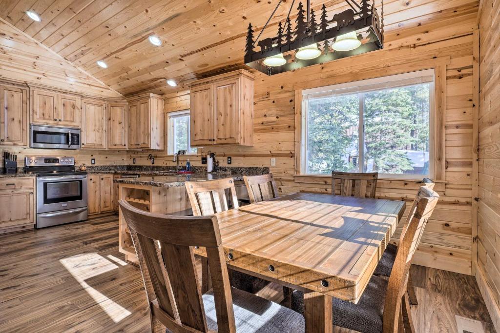 a kitchen with a wooden table in a cabin at Duck Creek Village Cabin with Fire Pit and Grill! in Duck Creek Village