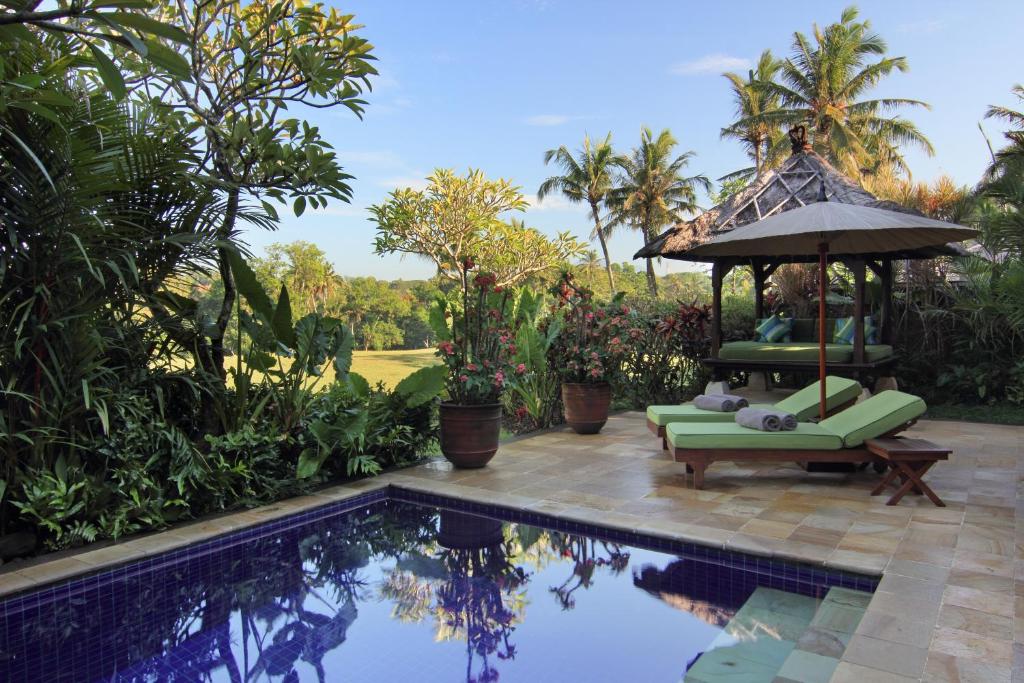 a villa with a pool and a gazebo at Villa Surya in Tanah Lot