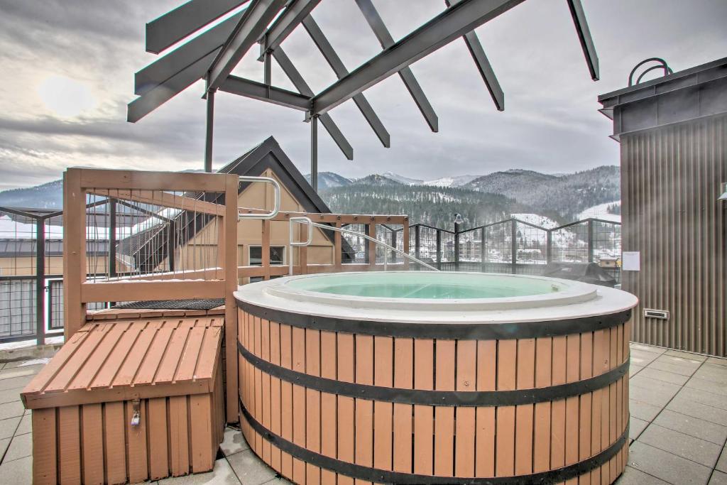 a hot tub on the roof of a building at Cozy Kellogg Condo - Ski at Silver Mountain Resort in Kellogg
