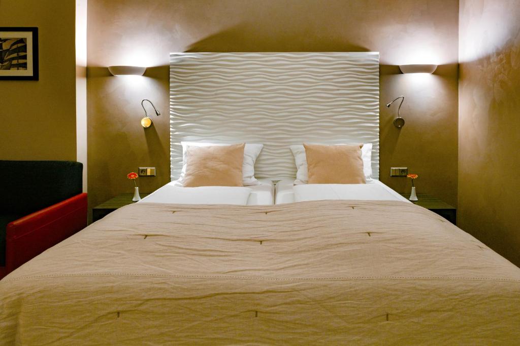 Postel nebo postele na pokoji v ubytování Artim Hotel
