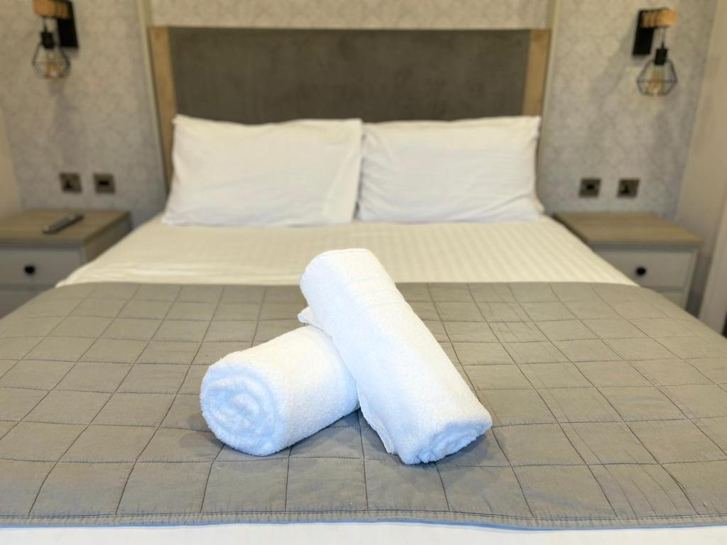 a bed with two rolls of toilet paper on it at Brackencroft Lodge with Hot Tub in York