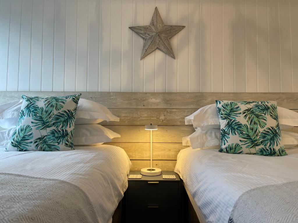 two beds sitting next to each other in a bedroom at Westward 14 Polzeath in Polzeath