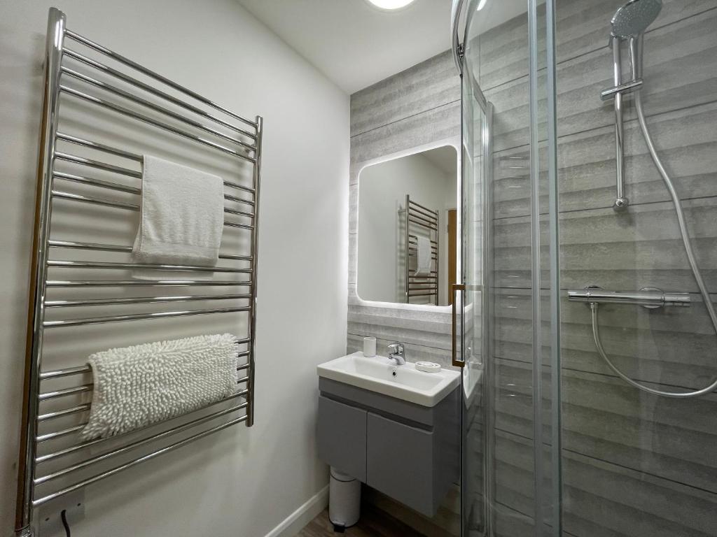 a bathroom with a sink and a shower at Westward 14 Polzeath in Polzeath