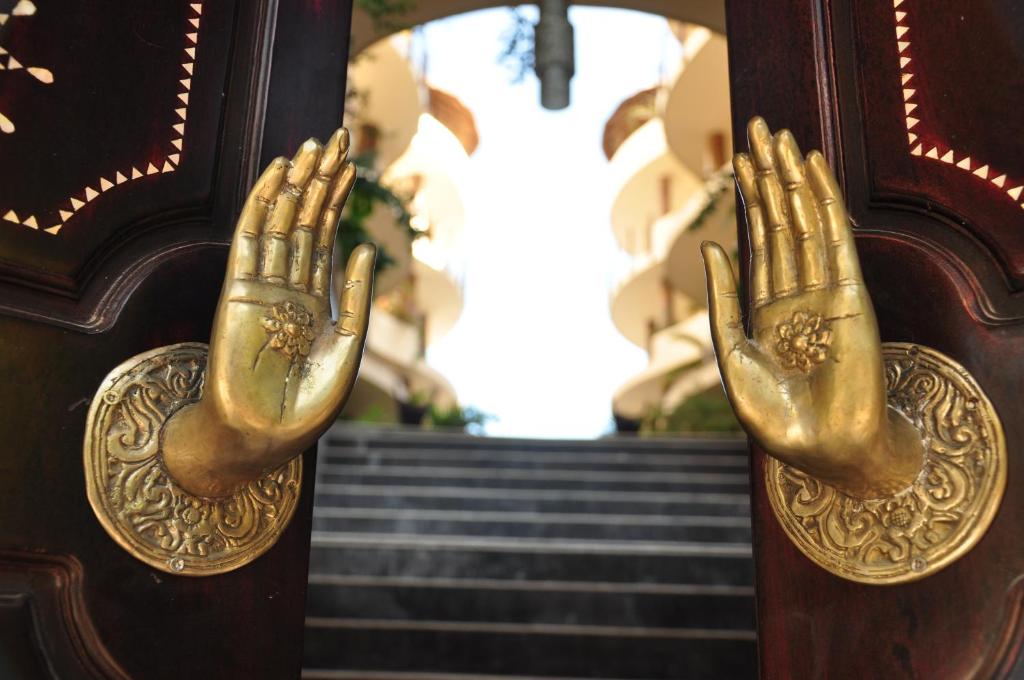 a door with a pair of hands on it at El Taj Oceanfront and Beachside Condo Hotel in Playa del Carmen