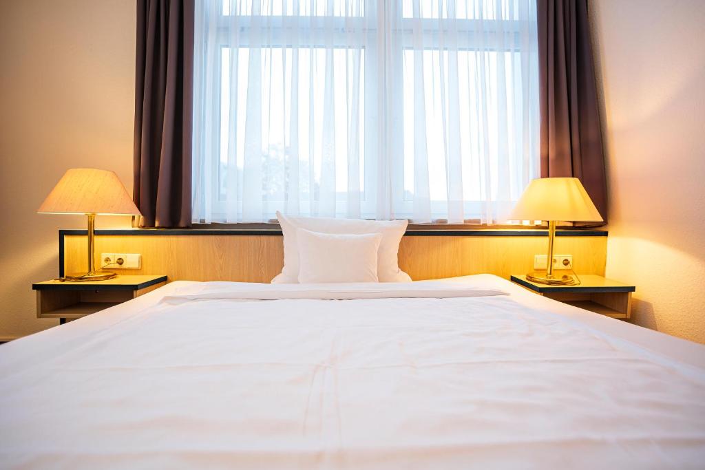 Postel nebo postele na pokoji v ubytování Apart' Hotel